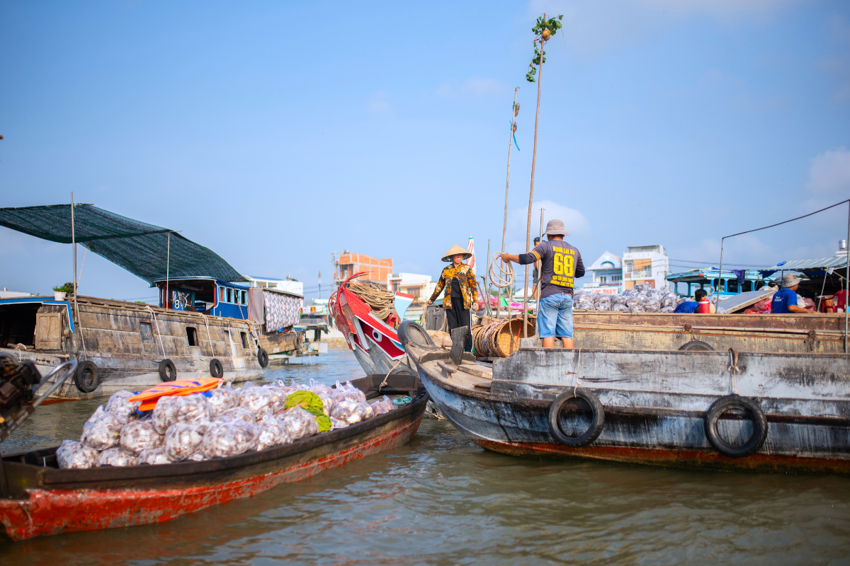 Bamboo poles adorned with goods, cleverly displayed on boats by local vendors