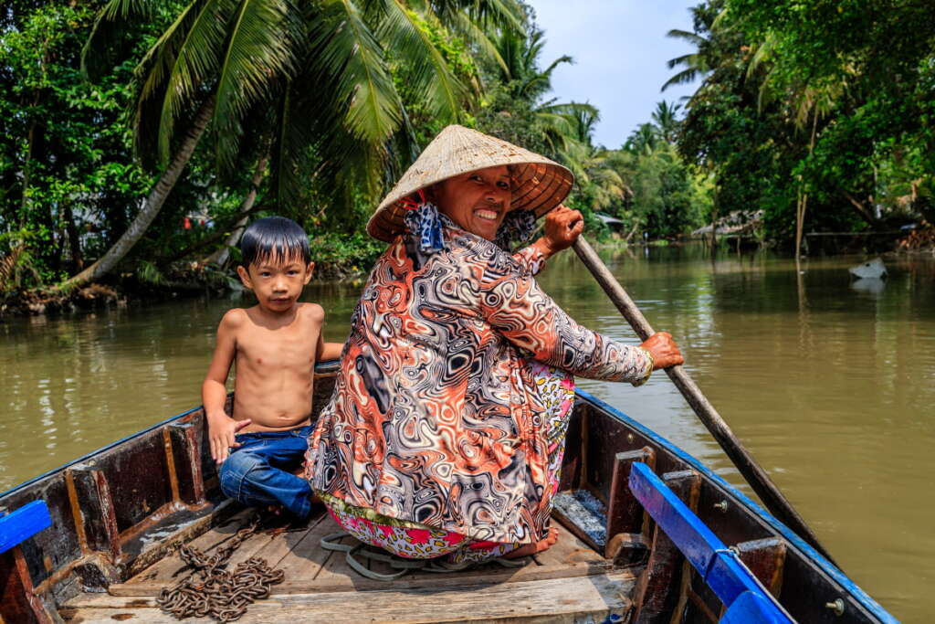 Boat rafting in Mekong Delta among green nature